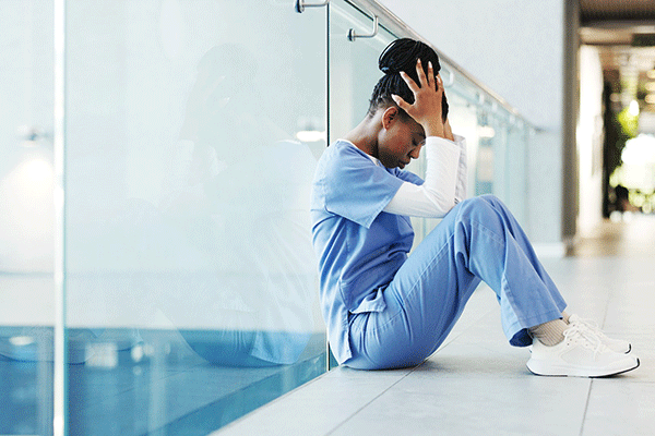 Nurse, woman and stress in clinic hallway for patient loss, bad news and medical trauma on floor. Health professional, black person or anxiety in corridor for healthcare fail, hospital grief or space